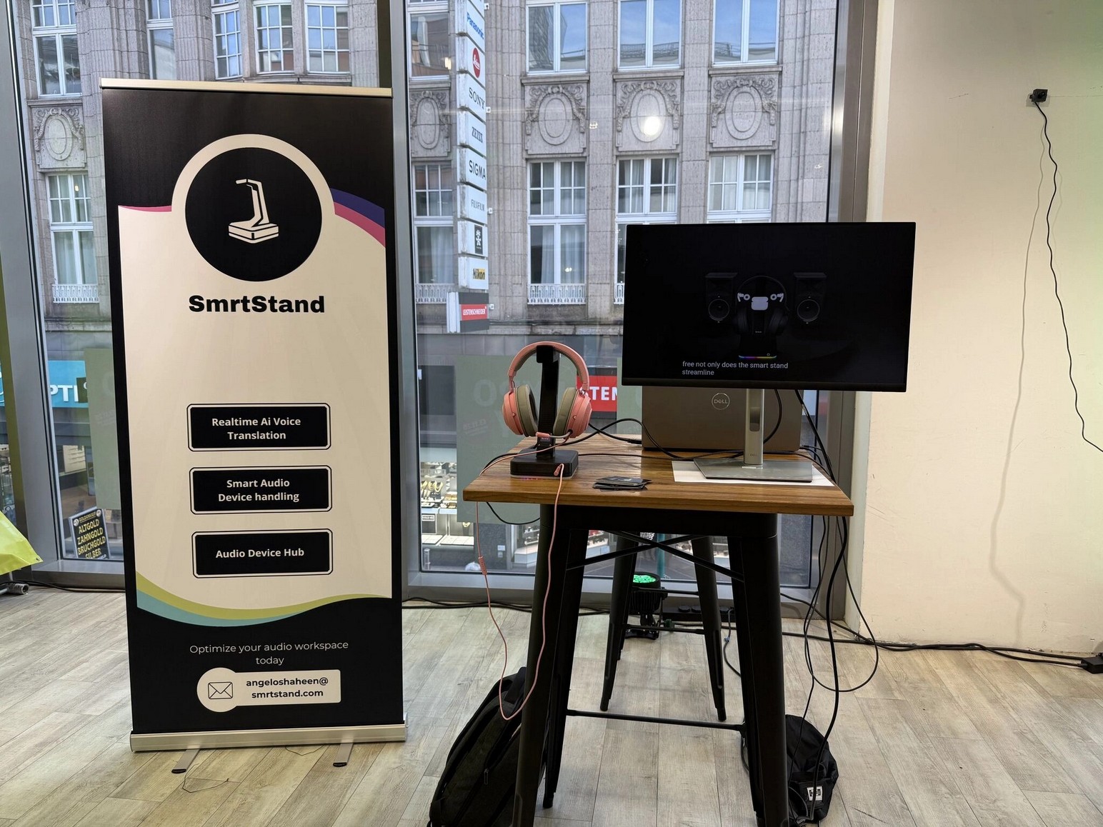 SmrtStand booth at a startup event — product, screen demo, branded rollup banner